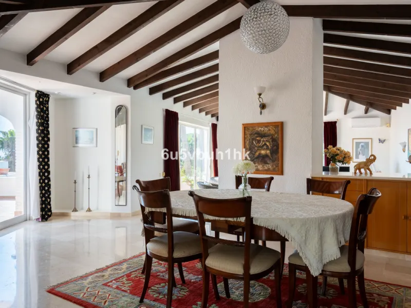 Hidden among palm trees and mature gardens in the established residential area of Sitio de Calahonda, this beautiful Andalusian villa captures the essence of traditional Mediterranean living. From the moment you arrive through the private gated entrance a