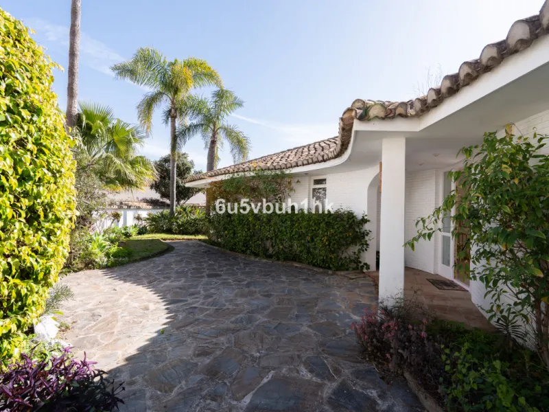 Hidden among palm trees and mature gardens in the established residential area of Sitio de Calahonda, this beautiful Andalusian villa captures the essence of traditional Mediterranean living. From the moment you arrive through the private gated entrance a