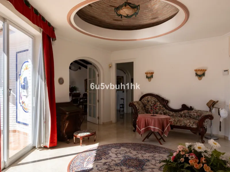 Hidden among palm trees and mature gardens in the established residential area of Sitio de Calahonda, this beautiful Andalusian villa captures the essence of traditional Mediterranean living. From the moment you arrive through the private gated entrance a