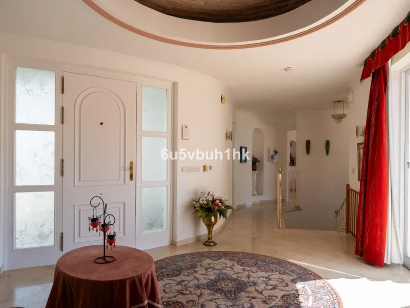 Hidden among palm trees and mature gardens in the established residential area of Sitio de Calahonda, this beautiful Andalusian villa captures the essence of traditional Mediterranean living. From the moment you arrive through the private gated entrance a