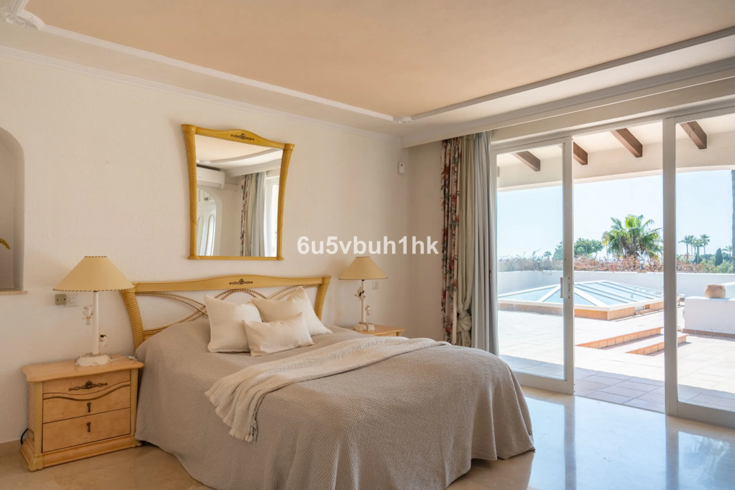 Hidden among palm trees and mature gardens in the established residential area of Sitio de Calahonda, this beautiful Andalusian villa captures the essence of traditional Mediterranean living. From the moment you arrive through the private gated entrance a