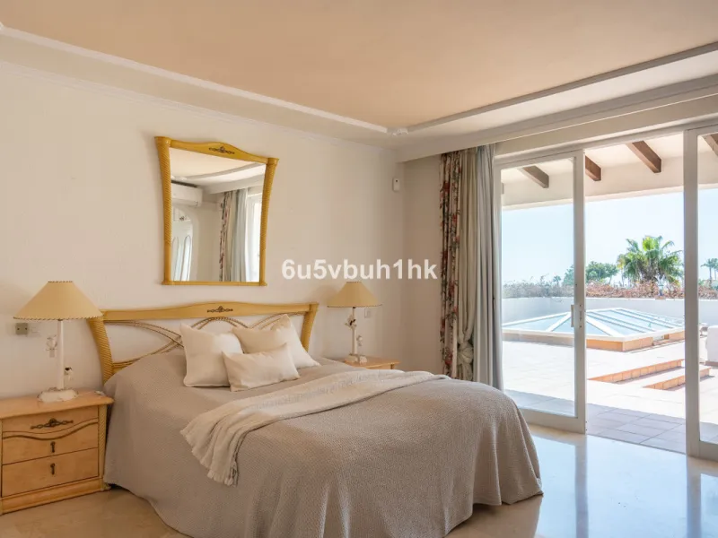 Hidden among palm trees and mature gardens in the established residential area of Sitio de Calahonda, this beautiful Andalusian villa captures the essence of traditional Mediterranean living. From the moment you arrive through the private gated entrance a
