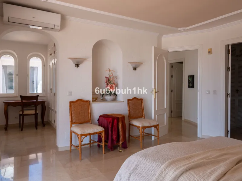 Hidden among palm trees and mature gardens in the established residential area of Sitio de Calahonda, this beautiful Andalusian villa captures the essence of traditional Mediterranean living. From the moment you arrive through the private gated entrance a
