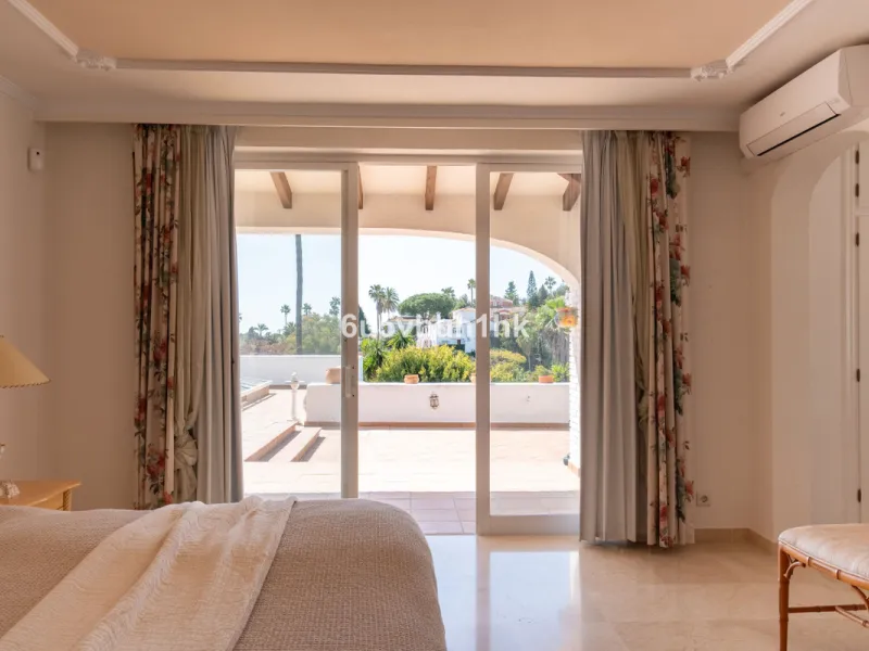 Hidden among palm trees and mature gardens in the established residential area of Sitio de Calahonda, this beautiful Andalusian villa captures the essence of traditional Mediterranean living. From the moment you arrive through the private gated entrance a
