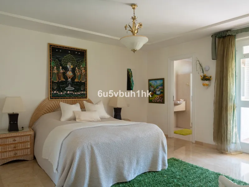Hidden among palm trees and mature gardens in the established residential area of Sitio de Calahonda, this beautiful Andalusian villa captures the essence of traditional Mediterranean living. From the moment you arrive through the private gated entrance a