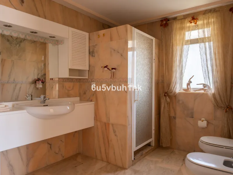 Hidden among palm trees and mature gardens in the established residential area of Sitio de Calahonda, this beautiful Andalusian villa captures the essence of traditional Mediterranean living. From the moment you arrive through the private gated entrance a