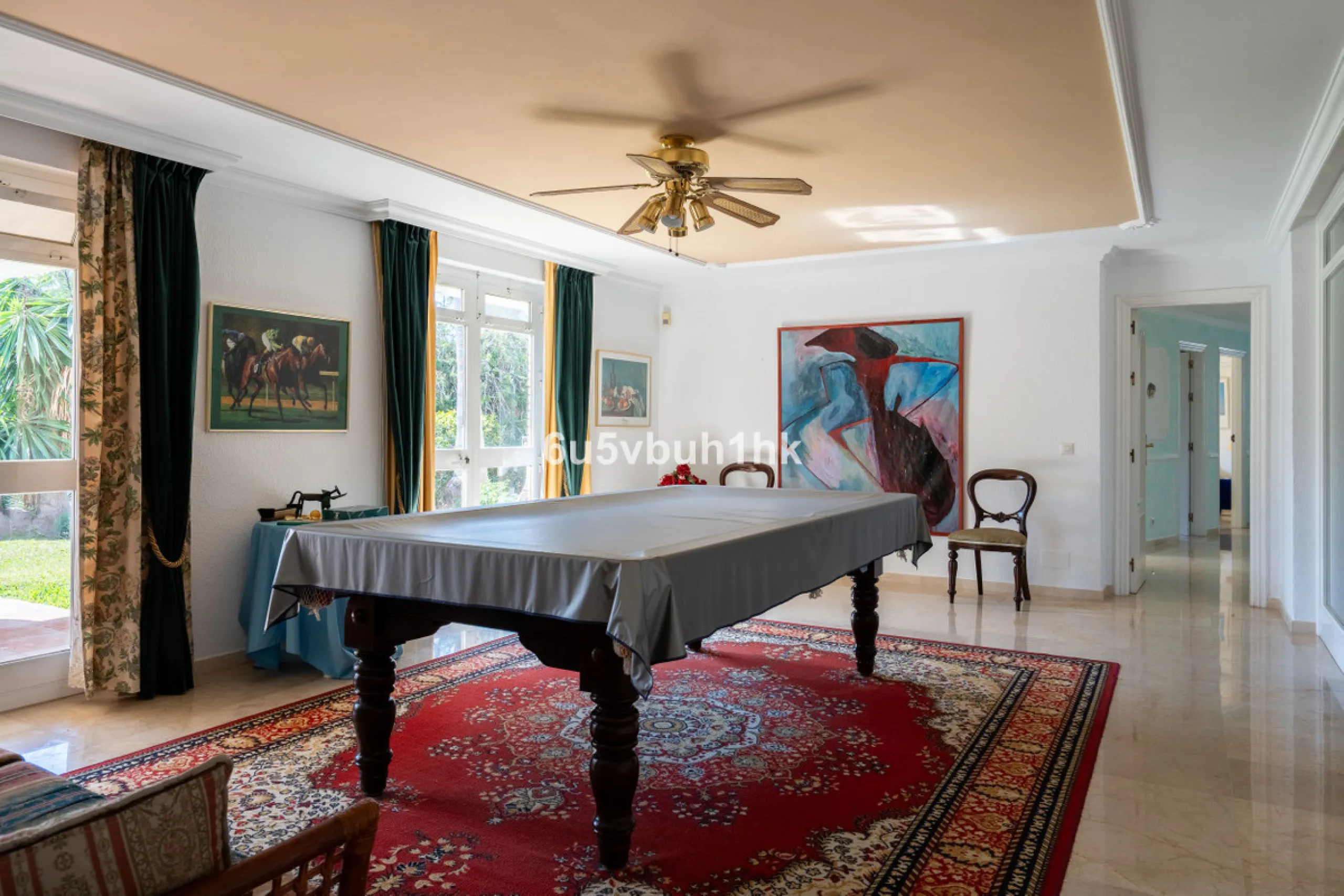 Hidden among palm trees and mature gardens in the established residential area of Sitio de Calahonda, this beautiful Andalusian villa captures the essence of traditional Mediterranean living. From the moment you arrive through the private gated entrance a