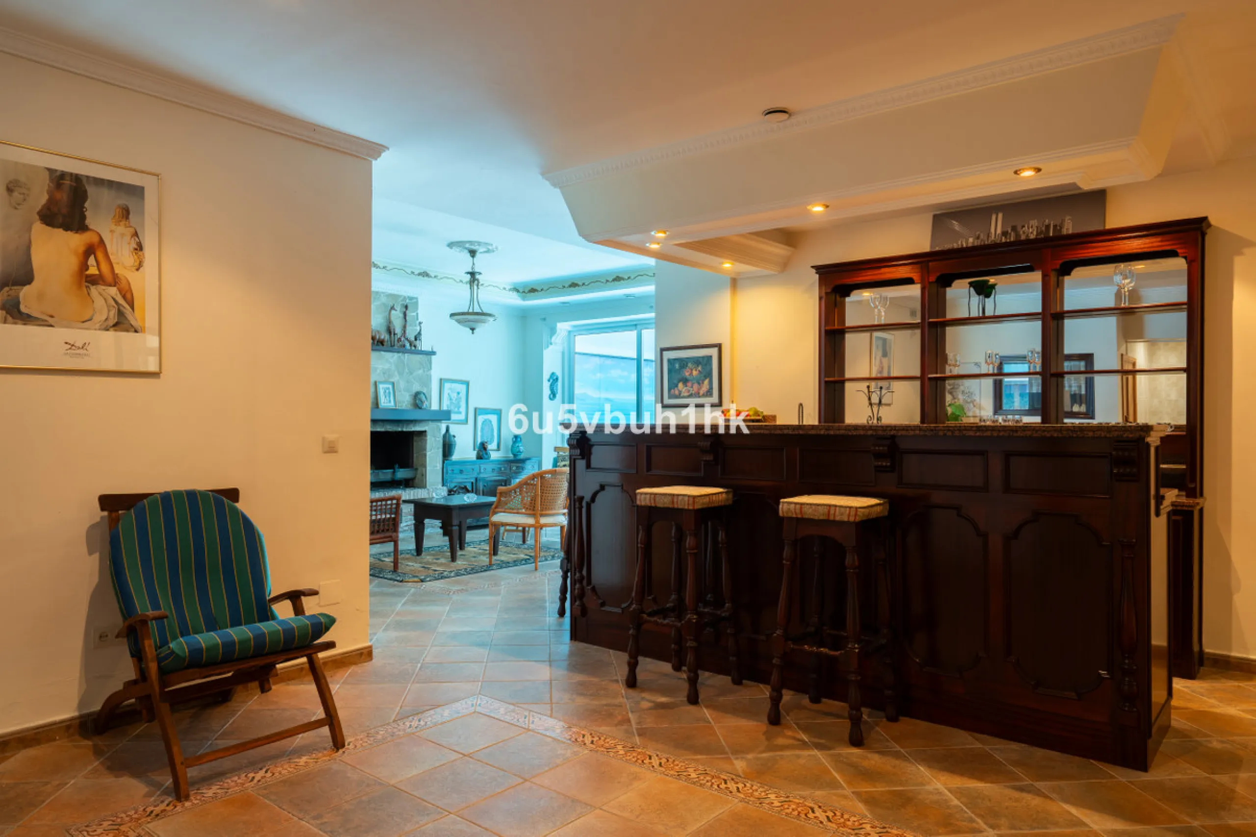 Hidden among palm trees and mature gardens in the established residential area of Sitio de Calahonda, this beautiful Andalusian villa captures the essence of traditional Mediterranean living. From the moment you arrive through the private gated entrance a