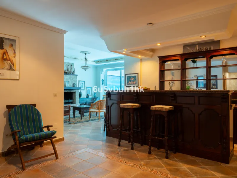Hidden among palm trees and mature gardens in the established residential area of Sitio de Calahonda, this beautiful Andalusian villa captures the essence of traditional Mediterranean living. From the moment you arrive through the private gated entrance a