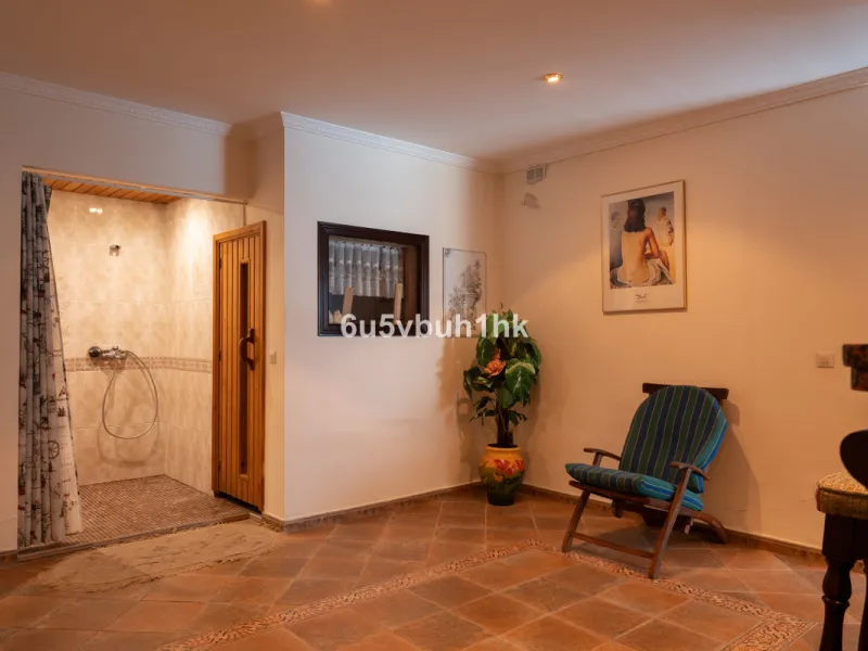 Hidden among palm trees and mature gardens in the established residential area of Sitio de Calahonda, this beautiful Andalusian villa captures the essence of traditional Mediterranean living. From the moment you arrive through the private gated entrance a