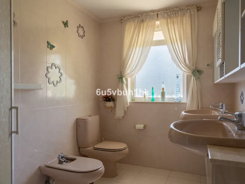 Hidden among palm trees and mature gardens in the established residential area of Sitio de Calahonda, this beautiful Andalusian villa captures the essence of traditional Mediterranean living. From the moment you arrive through the private gated entrance a