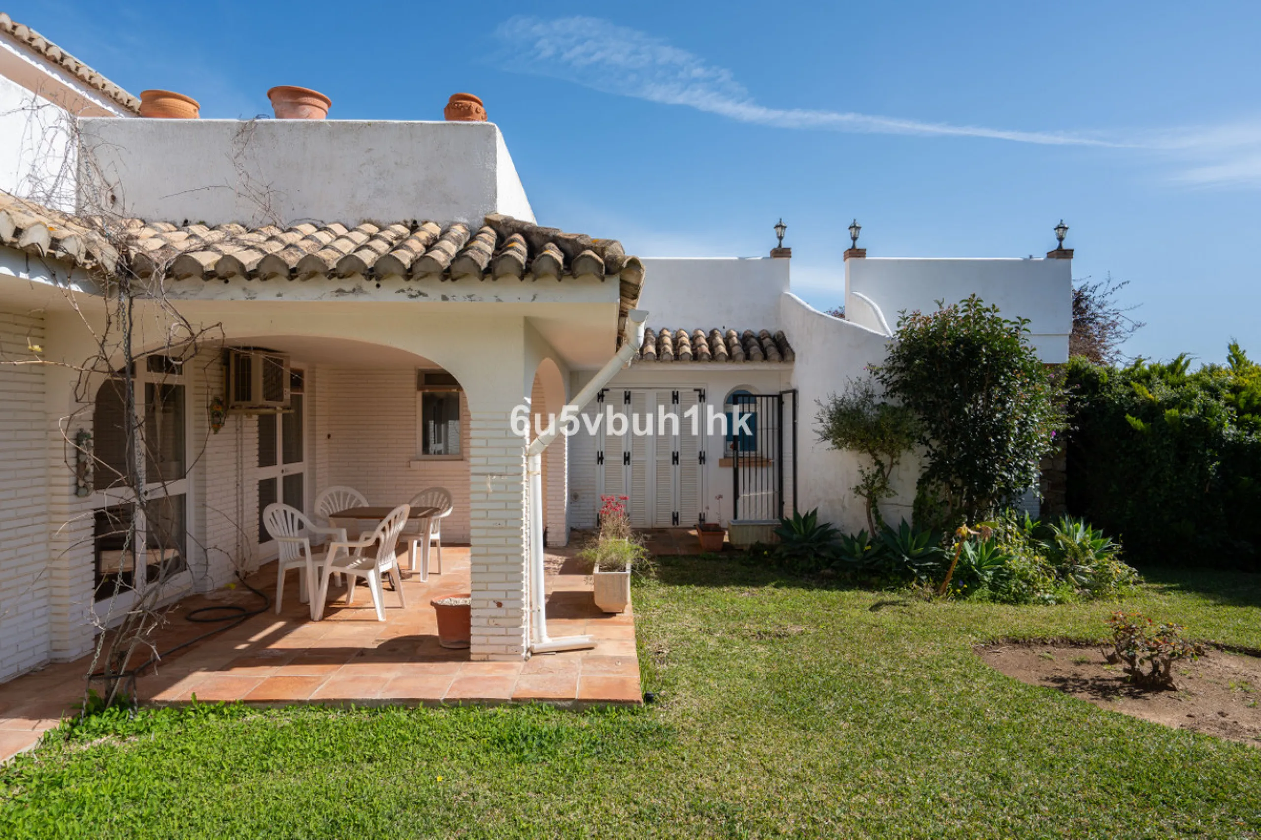 Hidden among palm trees and mature gardens in the established residential area of Sitio de Calahonda, this beautiful Andalusian villa captures the essence of traditional Mediterranean living. From the moment you arrive through the private gated entrance a
