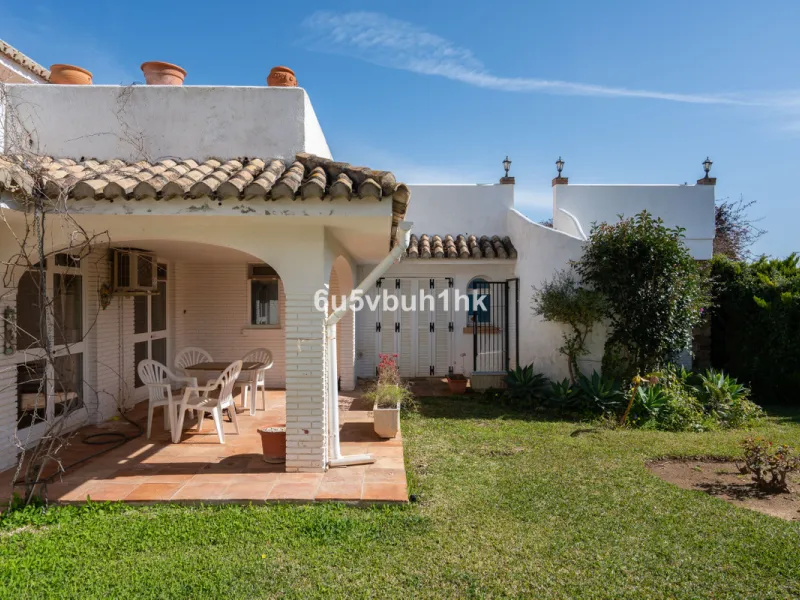Hidden among palm trees and mature gardens in the established residential area of Sitio de Calahonda, this beautiful Andalusian villa captures the essence of traditional Mediterranean living. From the moment you arrive through the private gated entrance a