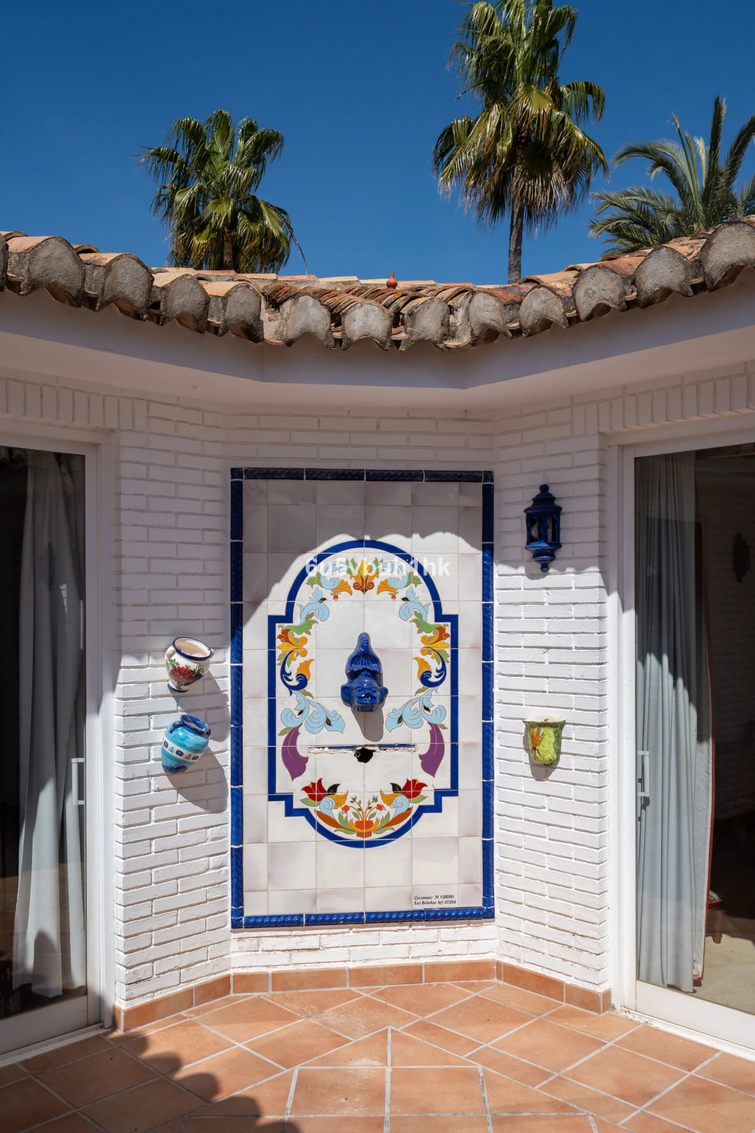 Hidden among palm trees and mature gardens in the established residential area of Sitio de Calahonda, this beautiful Andalusian villa captures the essence of traditional Mediterranean living. From the moment you arrive through the private gated entrance a