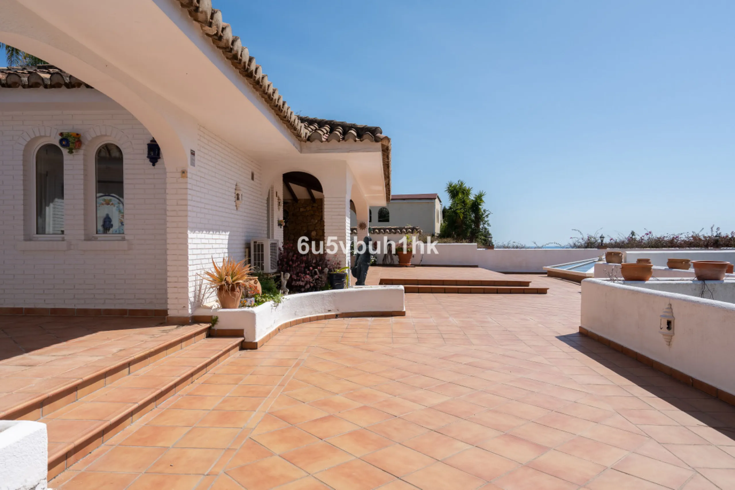 Hidden among palm trees and mature gardens in the established residential area of Sitio de Calahonda, this beautiful Andalusian villa captures the essence of traditional Mediterranean living. From the moment you arrive through the private gated entrance a