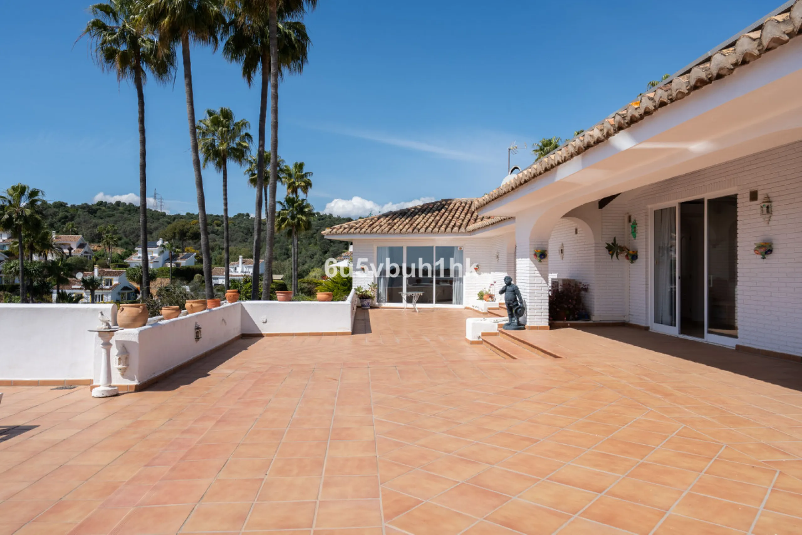 Hidden among palm trees and mature gardens in the established residential area of Sitio de Calahonda, this beautiful Andalusian villa captures the essence of traditional Mediterranean living. From the moment you arrive through the private gated entrance a