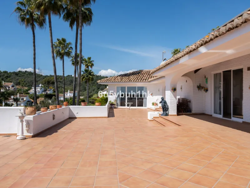 Hidden among palm trees and mature gardens in the established residential area of Sitio de Calahonda, this beautiful Andalusian villa captures the essence of traditional Mediterranean living. From the moment you arrive through the private gated entrance a