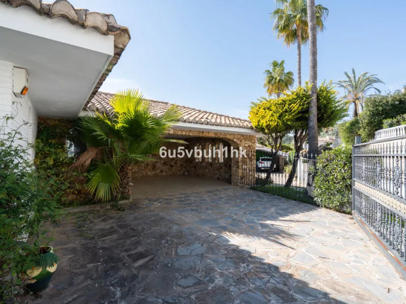Hidden among palm trees and mature gardens in the established residential area of Sitio de Calahonda, this beautiful Andalusian villa captures the essence of traditional Mediterranean living. From the moment you arrive through the private gated entrance a