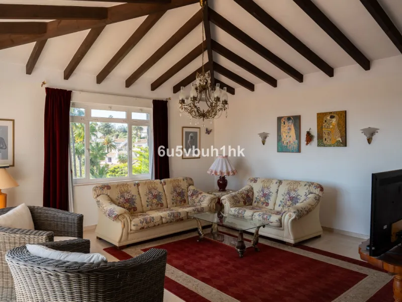 Hidden among palm trees and mature gardens in the established residential area of Sitio de Calahonda, this beautiful Andalusian villa captures the essence of traditional Mediterranean living. From the moment you arrive through the private gated entrance a