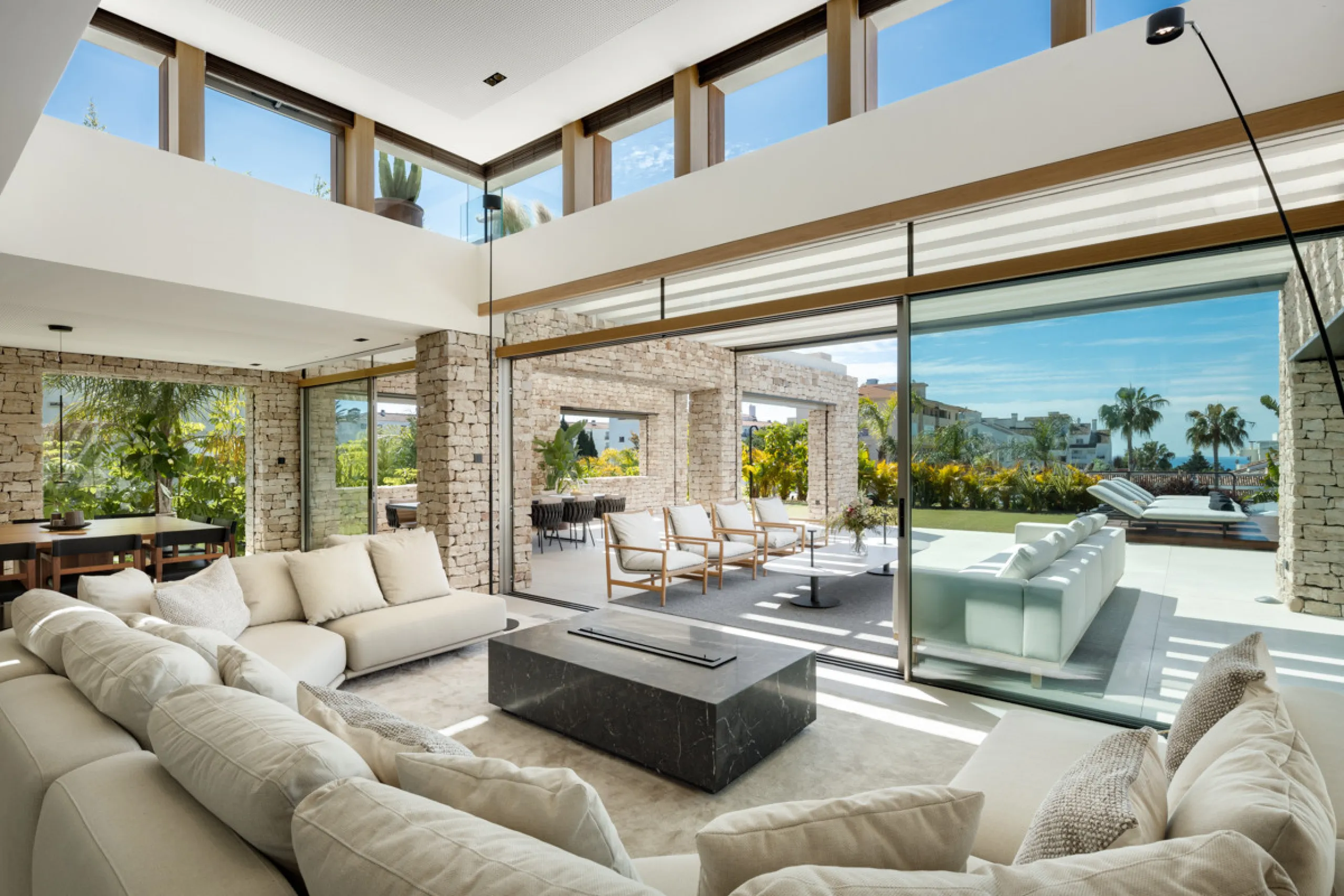 Nestled gracefully upon the verdant slopes of Nueva Andalucía, this villa is a triumph of modern elegance and luxurious design, an embodiment of serene sophistication. As you approach the property, you are greeted by a grand entrance framed by sleek lines