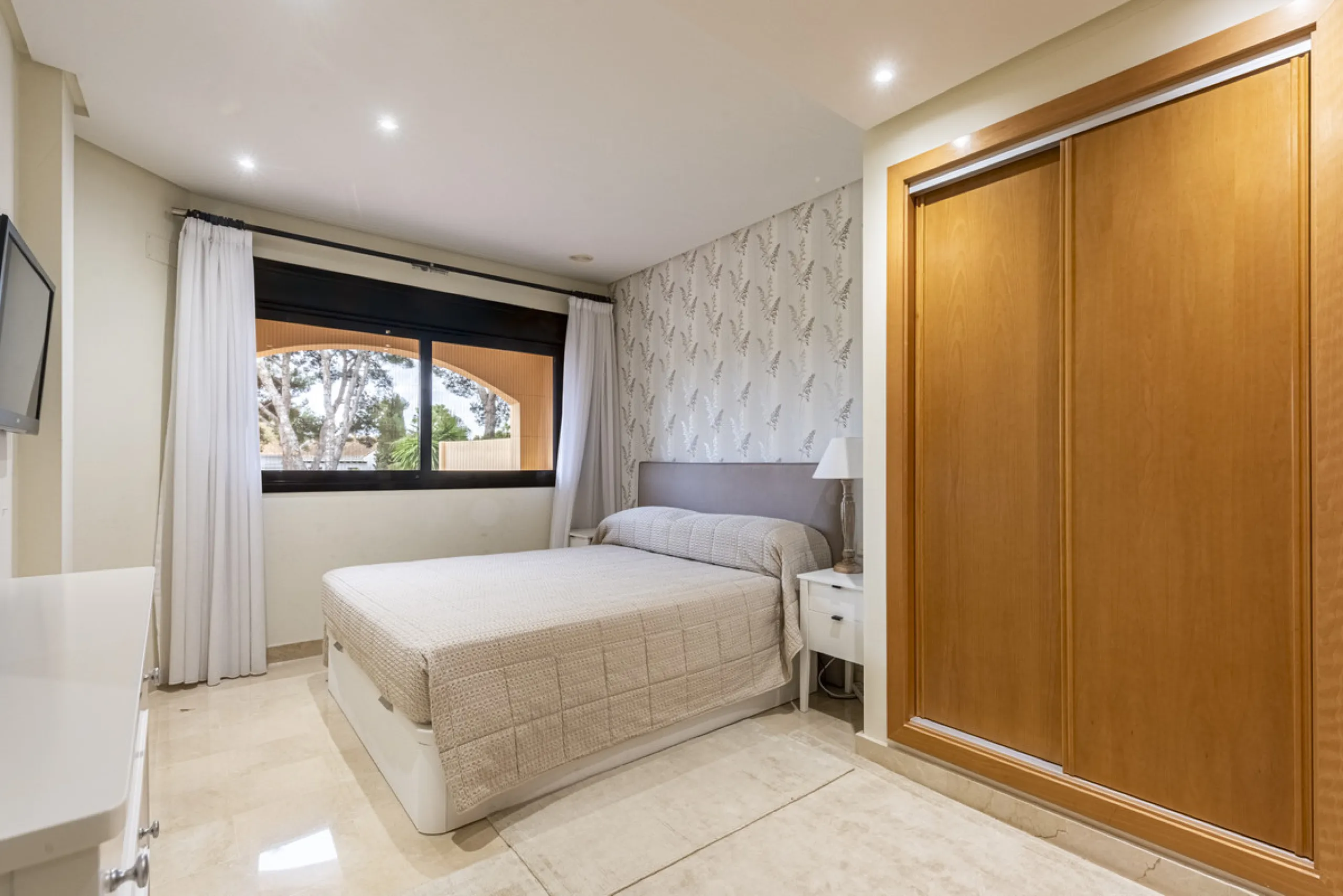 This modern and inviting two-bedroom apartment, nestled within the exclusive Las Mimosas complex, offers a truly exceptional living experience.