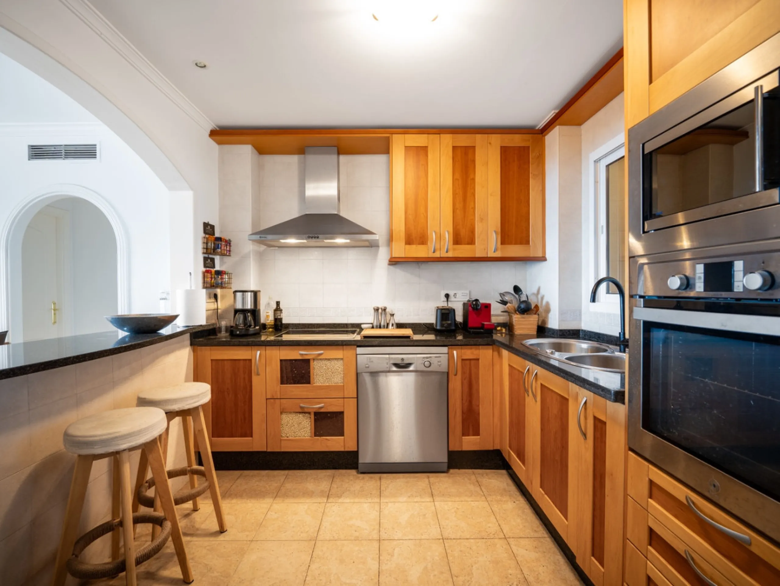 This penthouse is a 2 bedroom 2 bathroom duplex penthouse just 1 km from the beach. The home features open plan living spaces with bright interiors and large terrace windows. The kitchen overlooks the lounge and dining area through an elegant archway. The