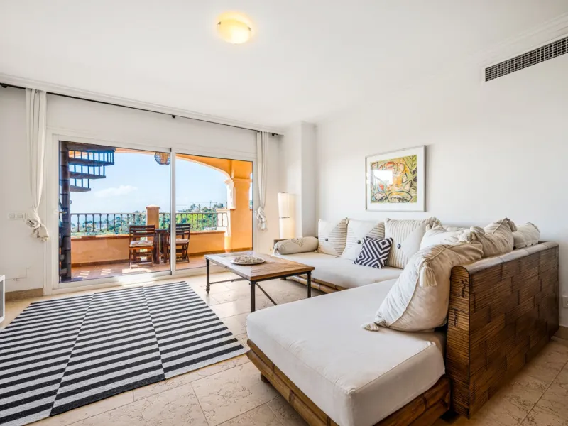 This penthouse is a 2 bedroom 2 bathroom duplex penthouse just 1 km from the beach. The home features open plan living spaces with bright interiors and large terrace windows. The kitchen overlooks the lounge and dining area through an elegant archway. The