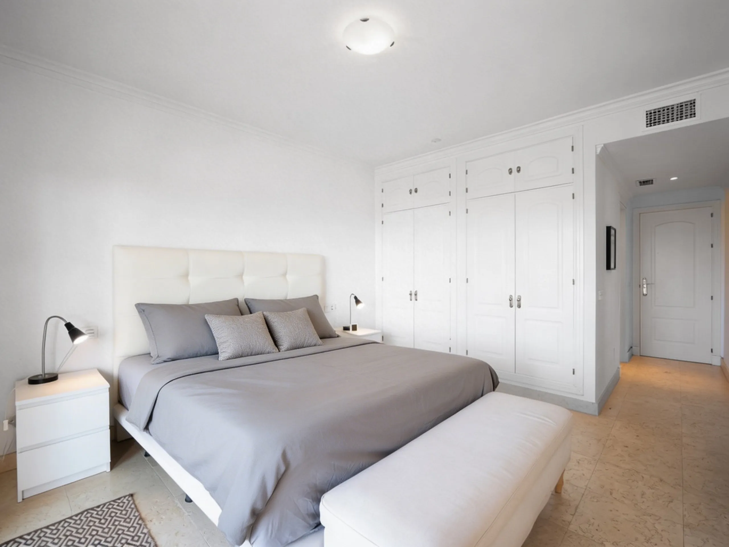 This penthouse is a 2 bedroom 2 bathroom duplex penthouse just 1 km from the beach. The home features open plan living spaces with bright interiors and large terrace windows. The kitchen overlooks the lounge and dining area through an elegant archway. The