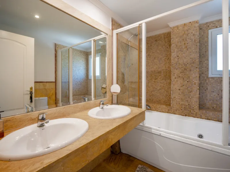 This penthouse is a 2 bedroom 2 bathroom duplex penthouse just 1 km from the beach. The home features open plan living spaces with bright interiors and large terrace windows. The kitchen overlooks the lounge and dining area through an elegant archway. The