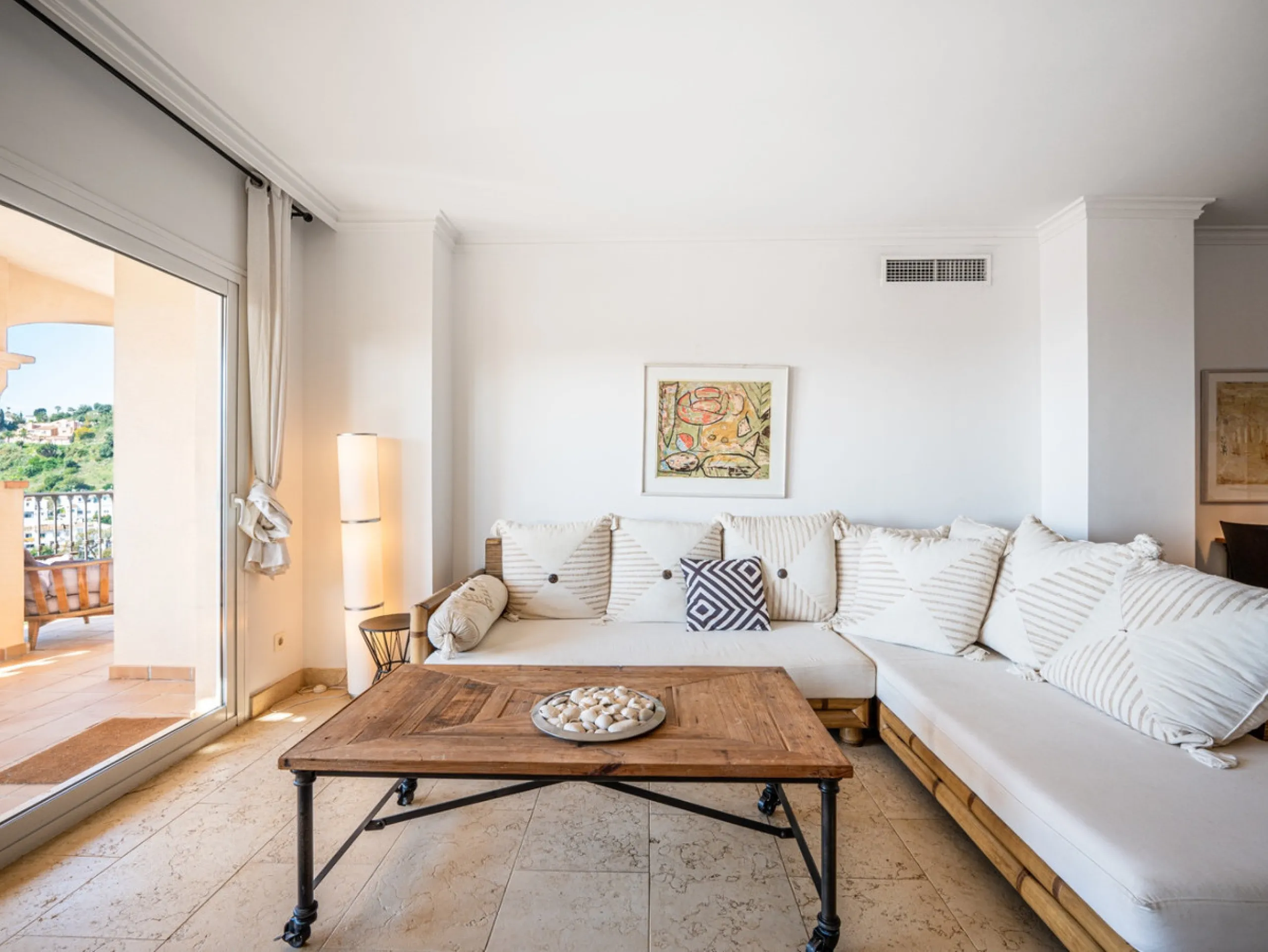 This penthouse is a 2 bedroom 2 bathroom duplex penthouse just 1 km from the beach. The home features open plan living spaces with bright interiors and large terrace windows. The kitchen overlooks the lounge and dining area through an elegant archway. The