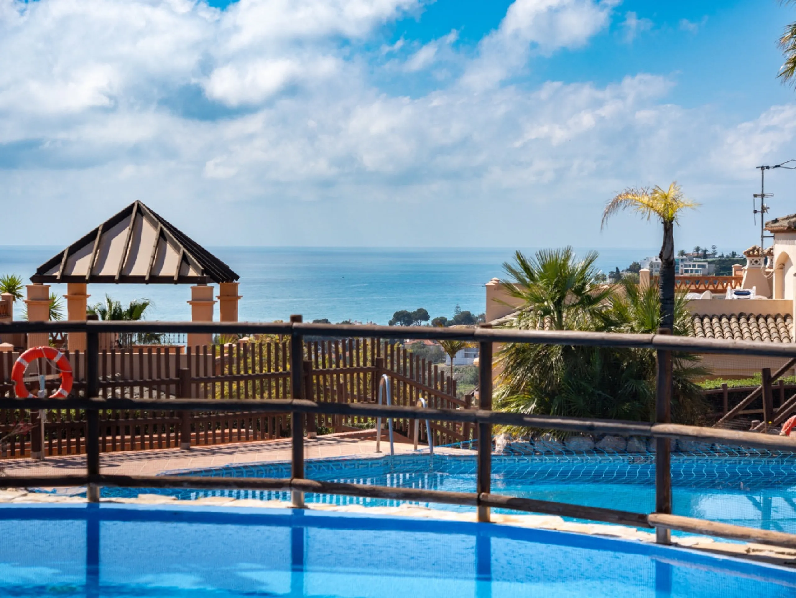 This penthouse is a 2 bedroom 2 bathroom duplex penthouse just 1 km from the beach. The home features open plan living spaces with bright interiors and large terrace windows. The kitchen overlooks the lounge and dining area through an elegant archway. The