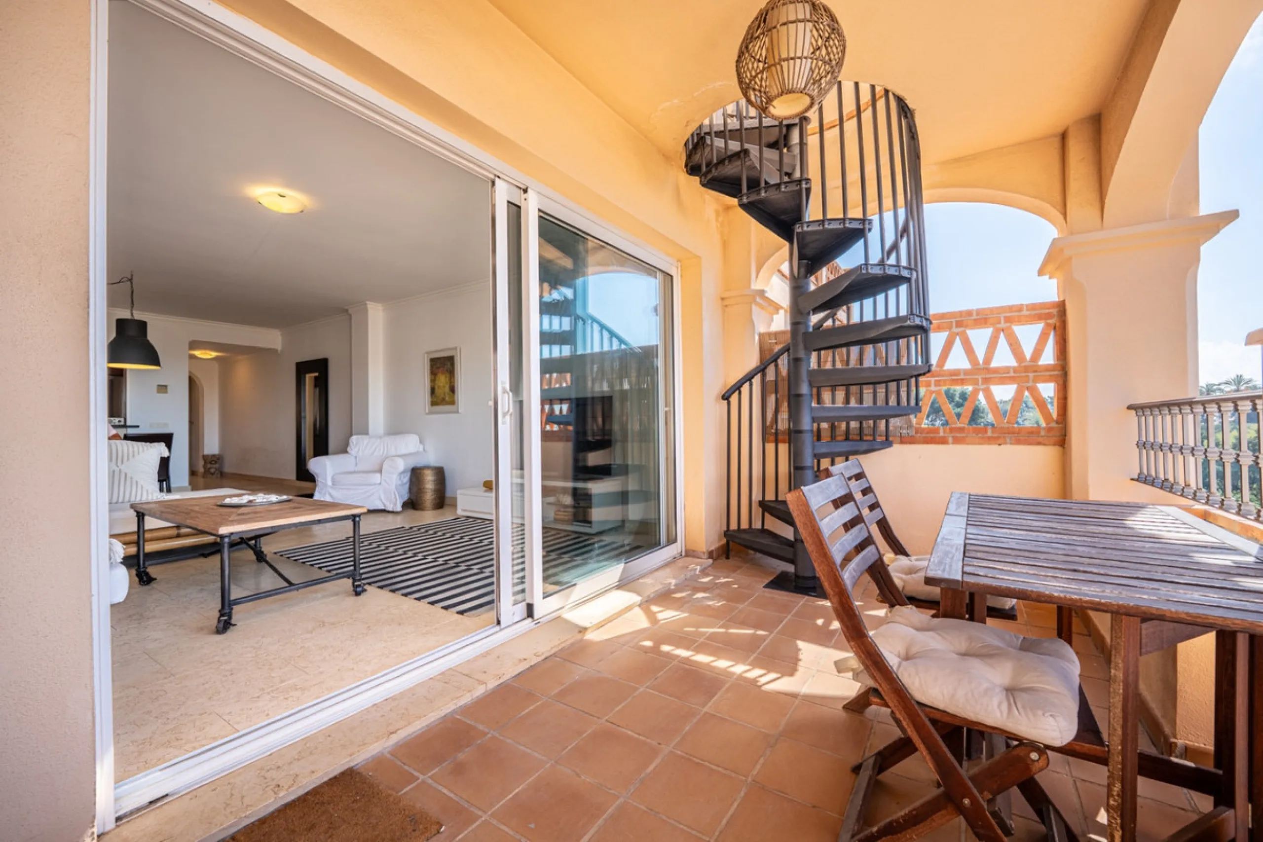 This penthouse is a 2 bedroom 2 bathroom duplex penthouse just 1 km from the beach. The home features open plan living spaces with bright interiors and large terrace windows. The kitchen overlooks the lounge and dining area through an elegant archway. The