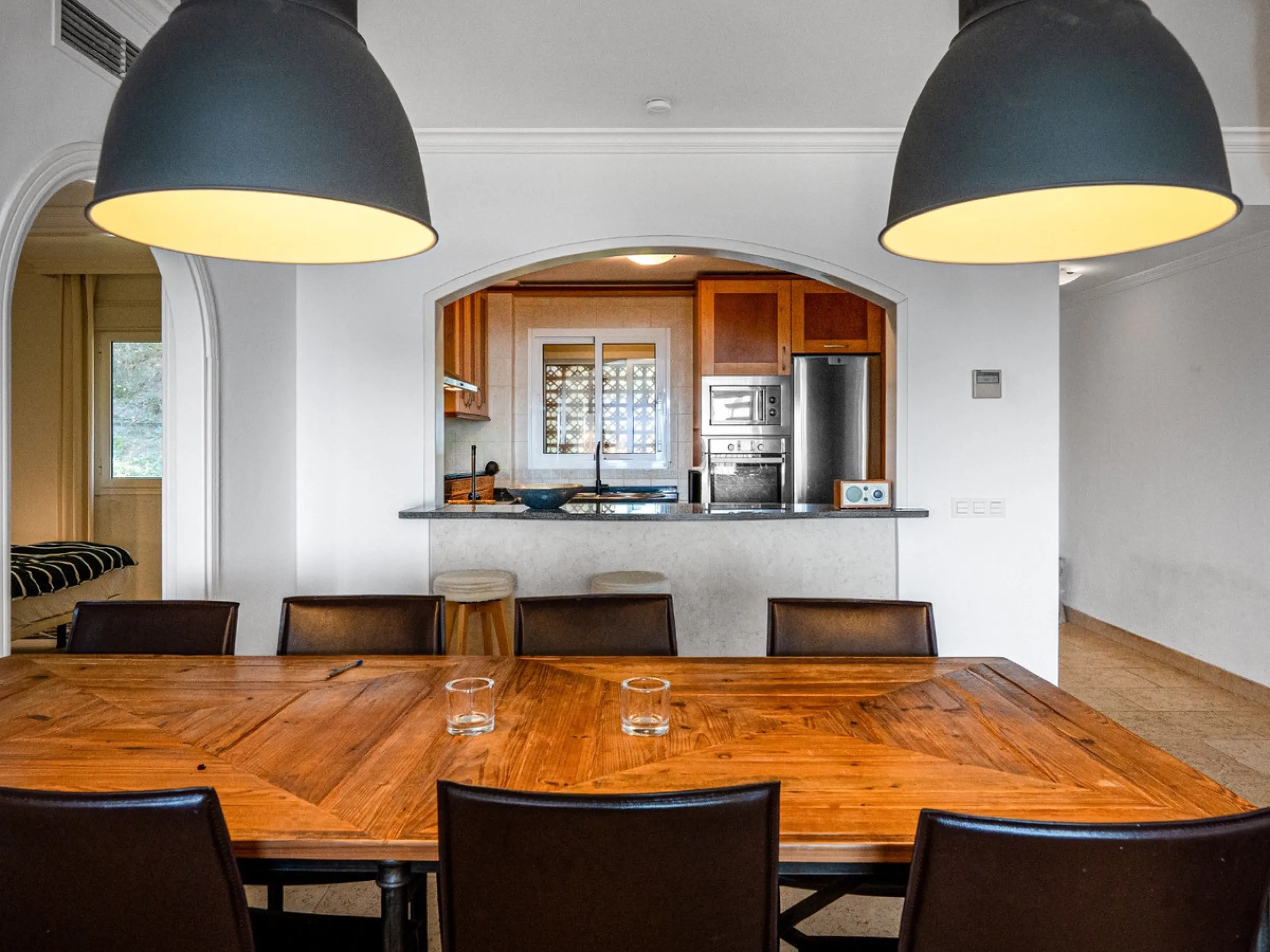 This penthouse is a 2 bedroom 2 bathroom duplex penthouse just 1 km from the beach. The home features open plan living spaces with bright interiors and large terrace windows. The kitchen overlooks the lounge and dining area through an elegant archway. The