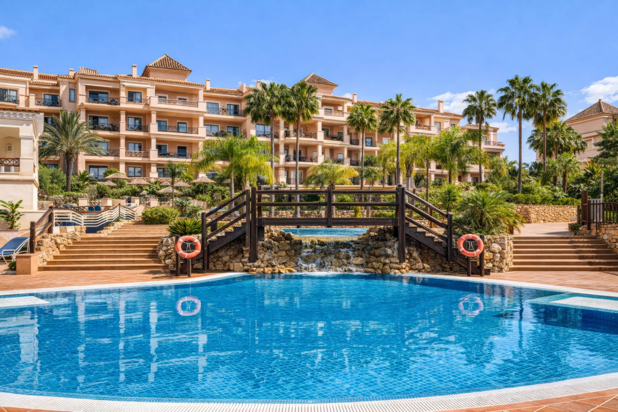 This penthouse is a 2 bedroom 2 bathroom duplex penthouse just 1 km from the beach. The home features open plan living spaces with bright interiors and large terrace windows. The kitchen overlooks the lounge and dining area through an elegant archway. The