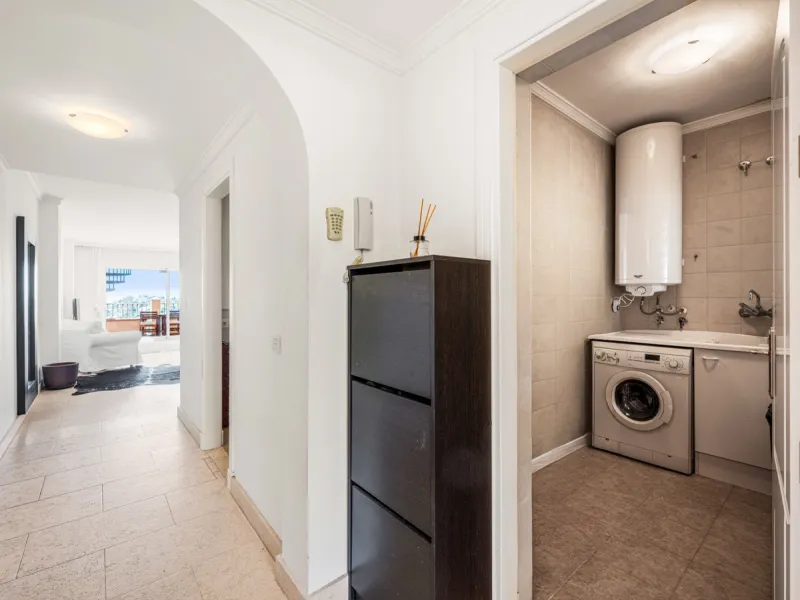 This penthouse is a 2 bedroom 2 bathroom duplex penthouse just 1 km from the beach. The home features open plan living spaces with bright interiors and large terrace windows. The kitchen overlooks the lounge and dining area through an elegant archway. The