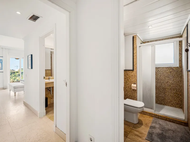 This penthouse is a 2 bedroom 2 bathroom duplex penthouse just 1 km from the beach. The home features open plan living spaces with bright interiors and large terrace windows. The kitchen overlooks the lounge and dining area through an elegant archway. The