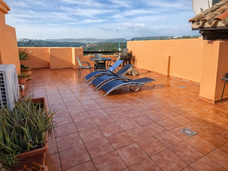 Morning arrives gently in Casares Playa. From your penthouse terrace, the first light spills across the gardens, catching the still surface of the pool and turning it into a soft shimmer. You slide open the terrace doors, step outside, and breathe in the 
