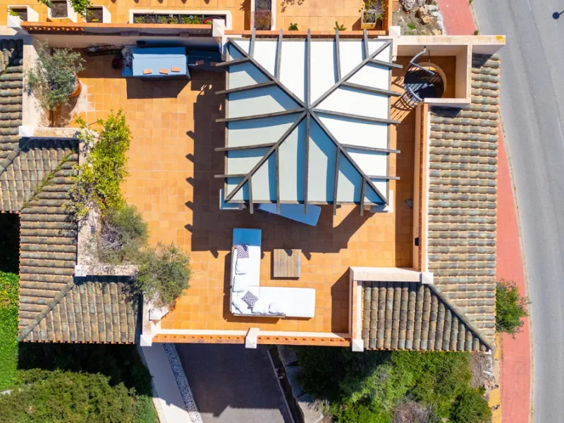 This penthouse is a 2 bedroom 2 bathroom duplex penthouse just 1 km from the beach. The home features open plan living spaces with bright interiors and large terrace windows. The kitchen overlooks the lounge and dining area through an elegant archway. The