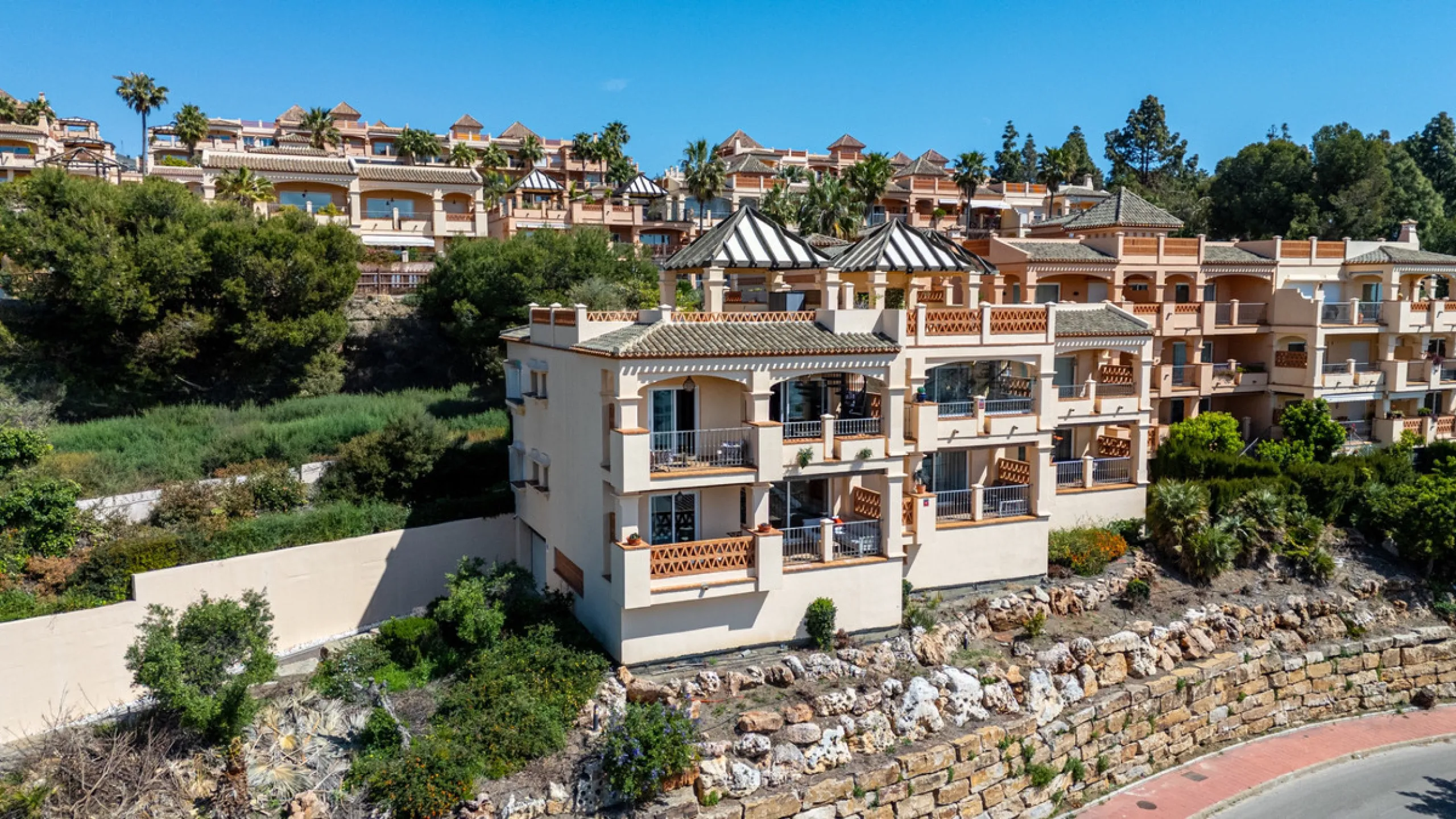 This penthouse is a 2 bedroom 2 bathroom duplex penthouse just 1 km from the beach. The home features open plan living spaces with bright interiors and large terrace windows. The kitchen overlooks the lounge and dining area through an elegant archway. The