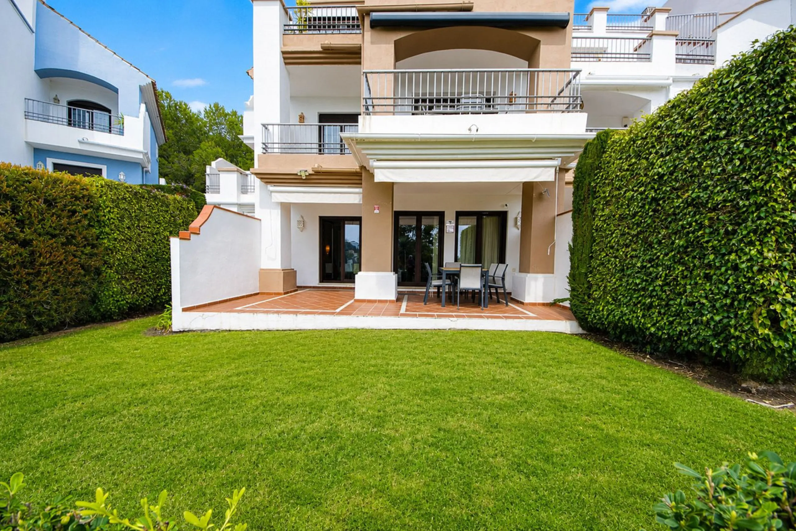 Ground floor apartment with private garden, open views, and 4 communal swimming pools.