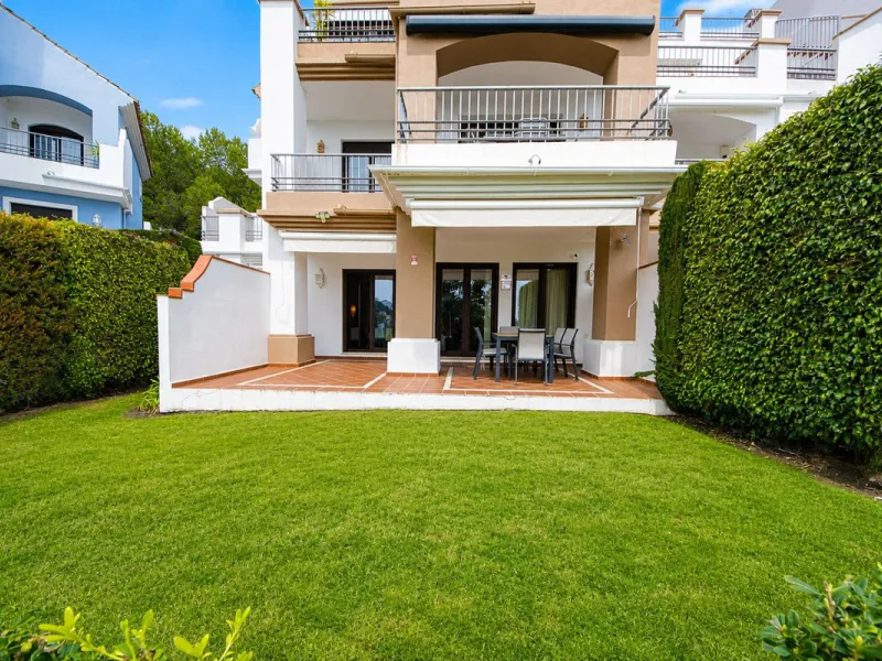 Ground floor apartment with private garden, open views, and 4 communal swimming pools.
