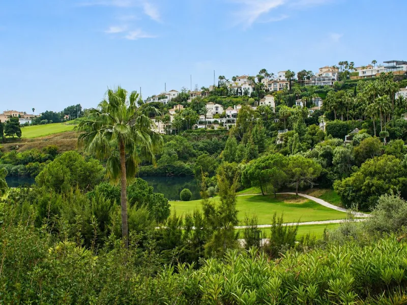 Ground floor apartment with private garden, open views, and 4 communal swimming pools.