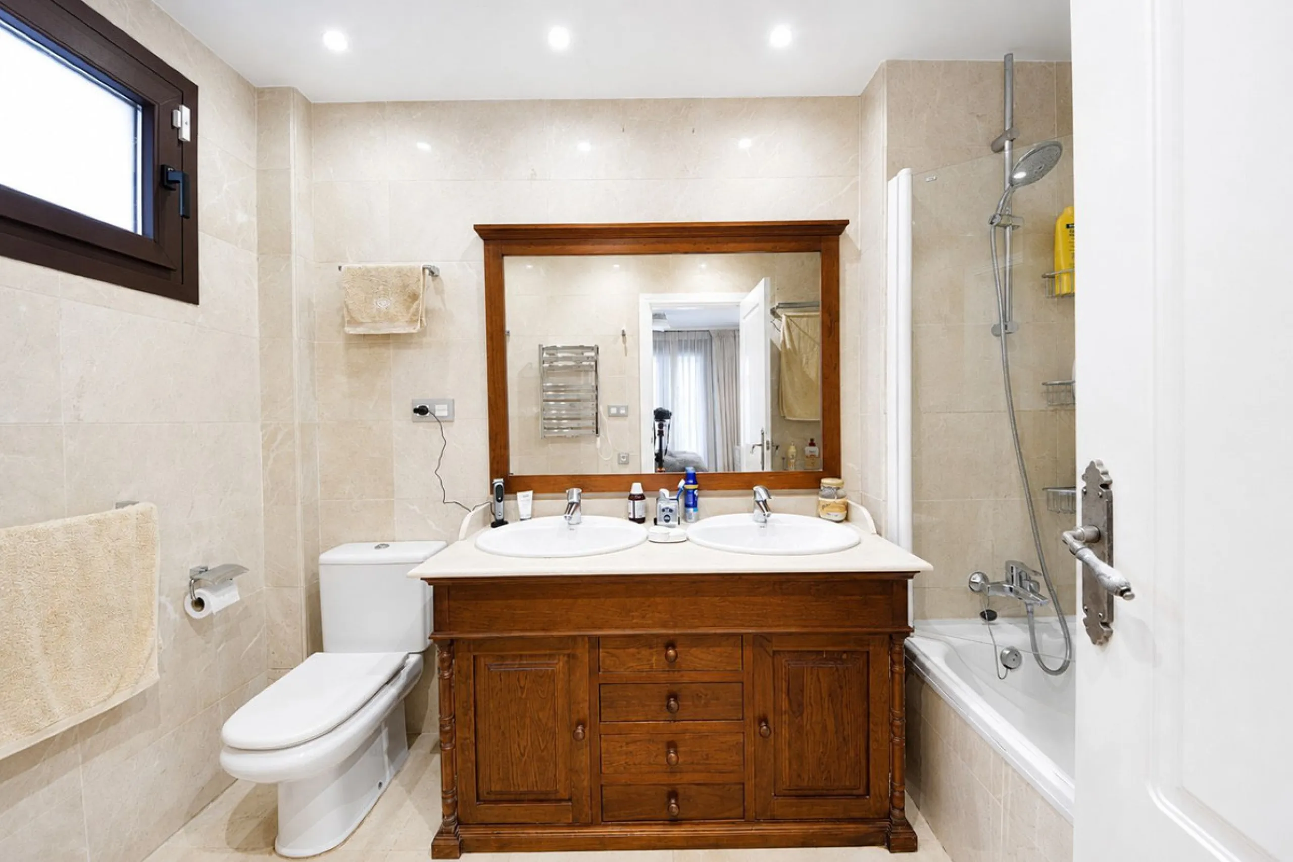 Ground floor apartment with private garden, open views, and 4 communal swimming pools.