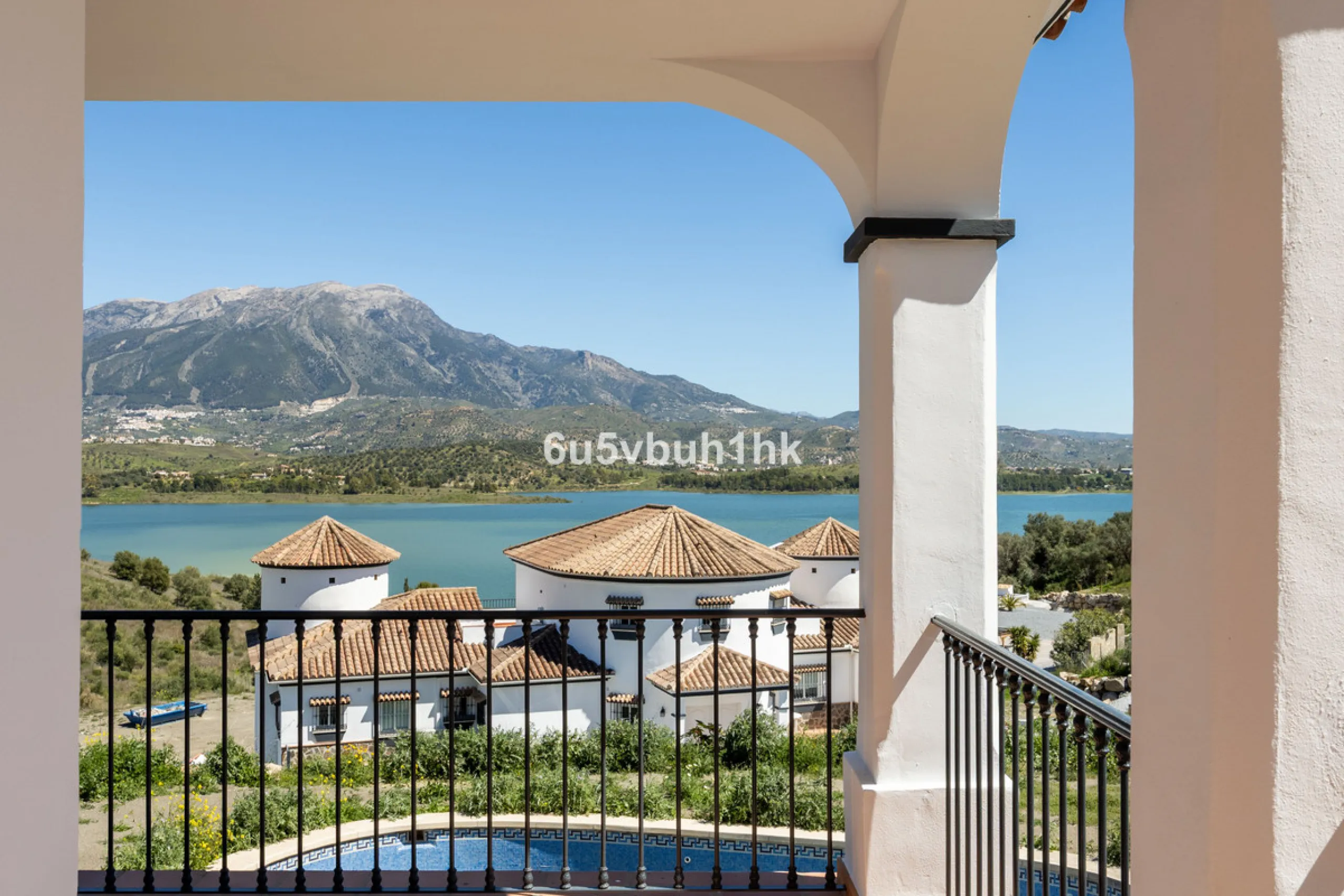 Some houses have a view. This one has a lake at its feet and a mountain range as its frame.