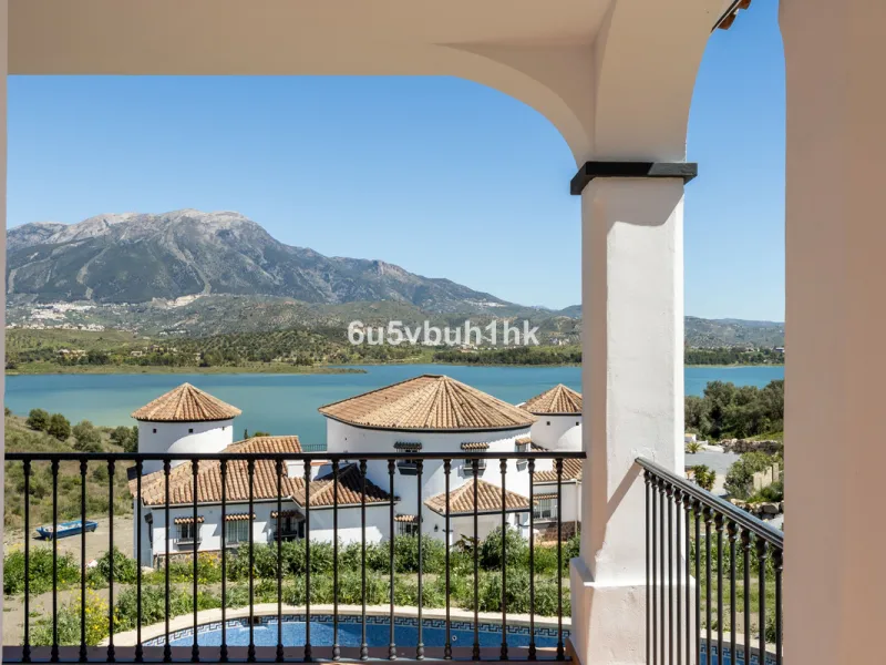 Some houses have a view. This one has a lake at its feet and a mountain range as its frame.