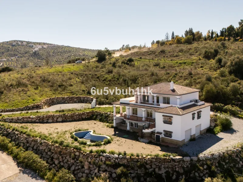 Some houses have a view. This one has a lake at its feet and a mountain range as its frame.