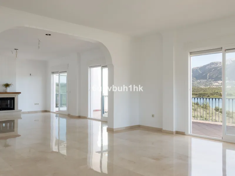 Some houses have a view. This one has a lake at its feet and a mountain range as its frame.