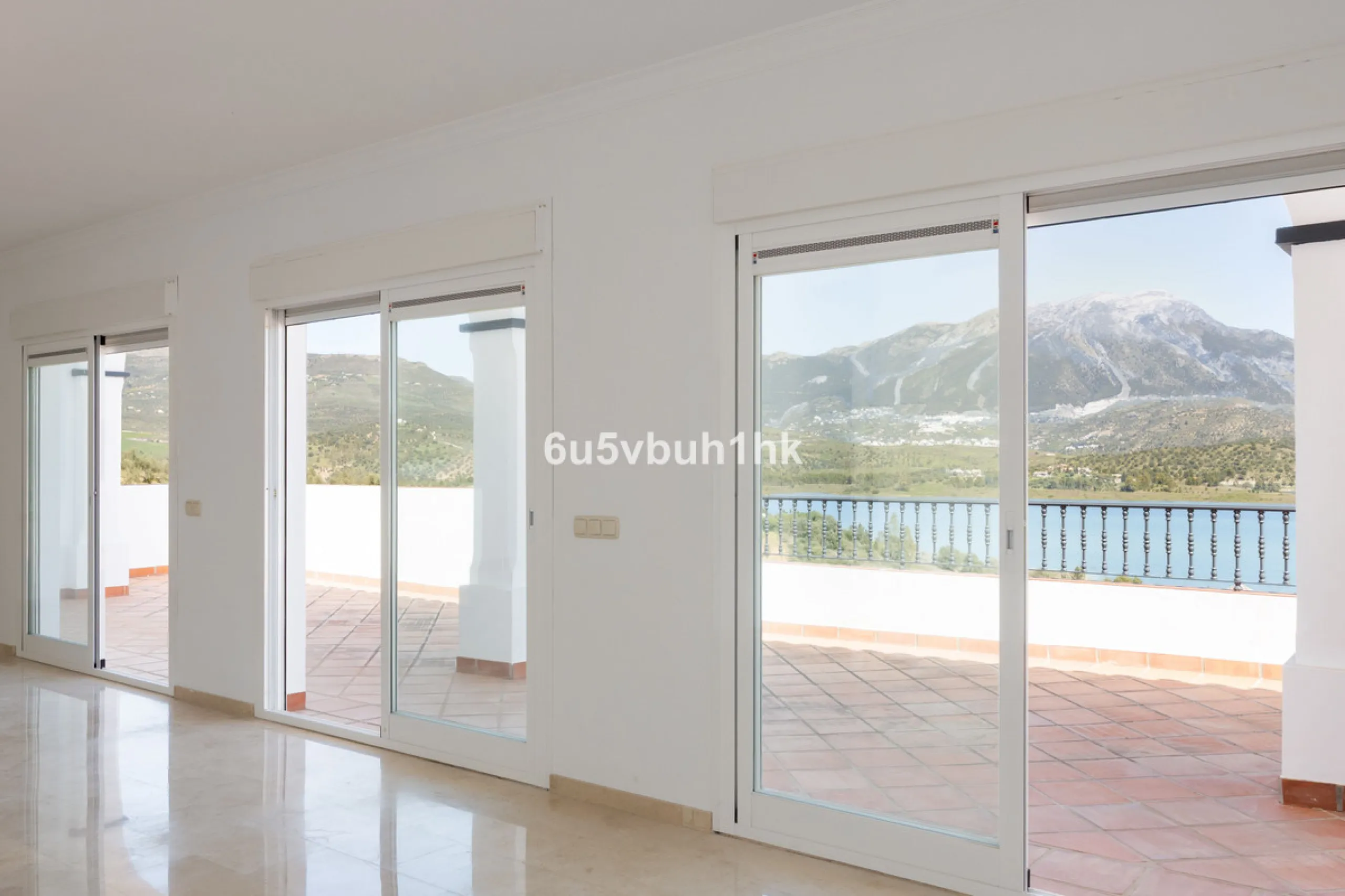 Some houses have a view. This one has a lake at its feet and a mountain range as its frame.