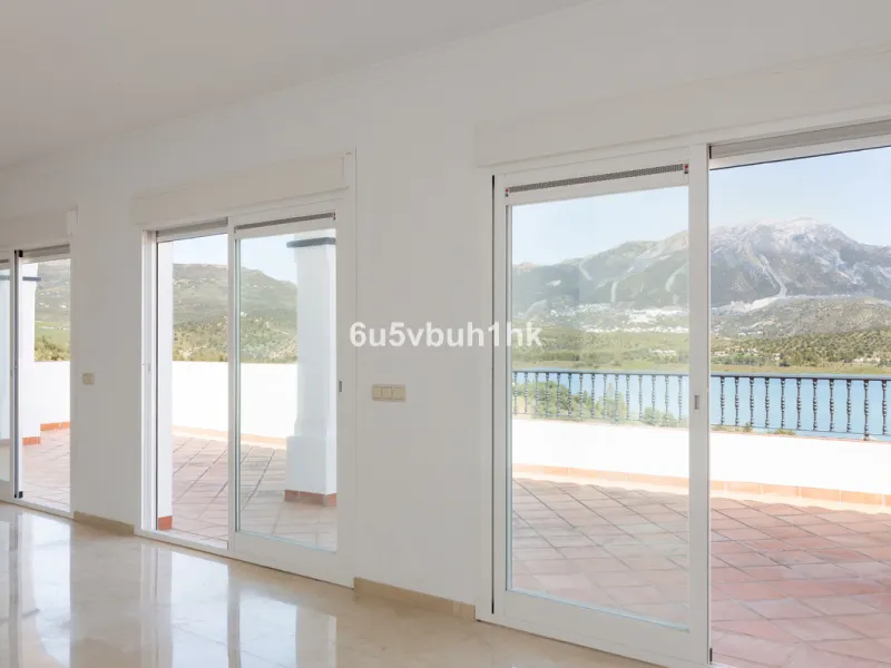 Some houses have a view. This one has a lake at its feet and a mountain range as its frame.