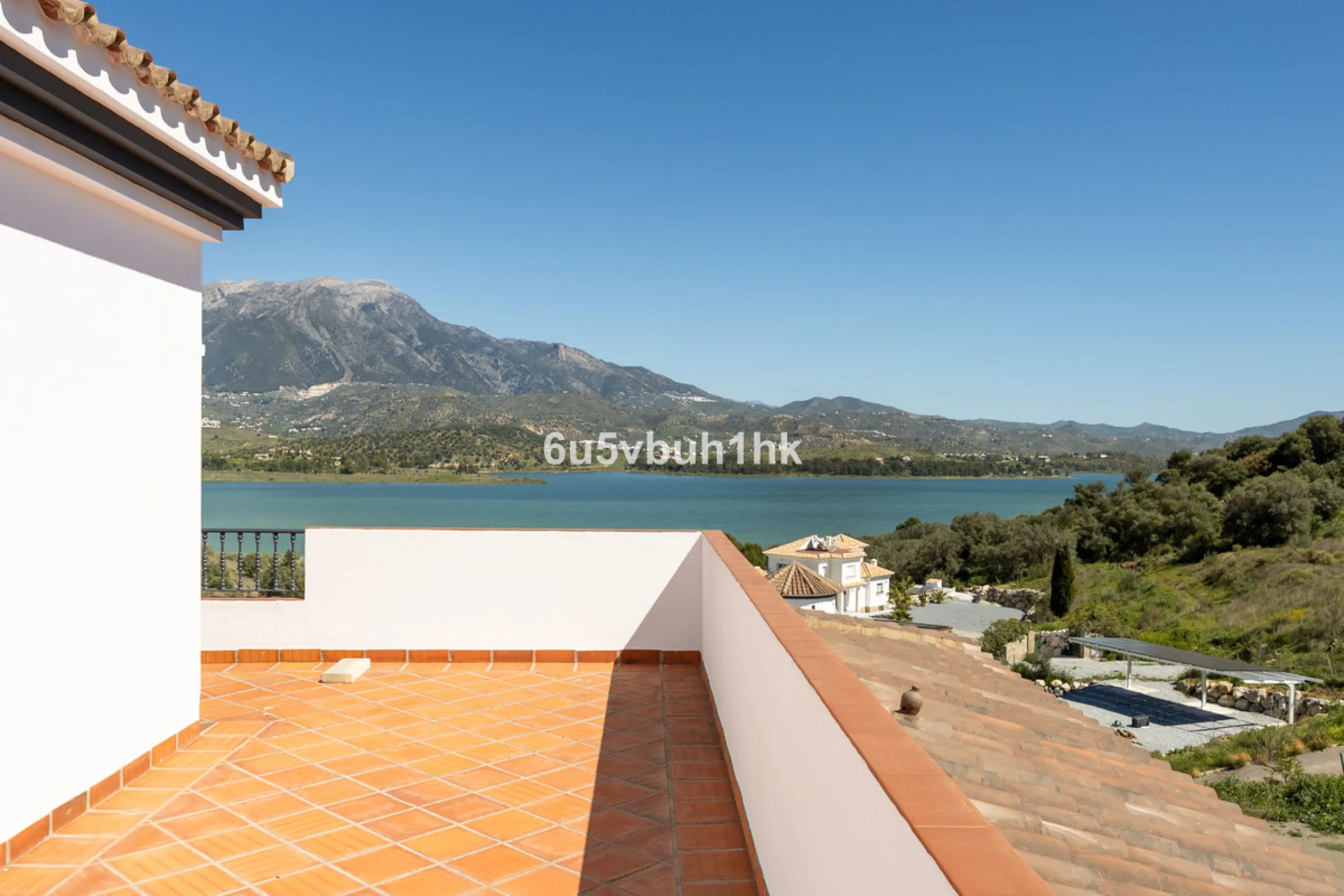 Some houses have a view. This one has a lake at its feet and a mountain range as its frame.